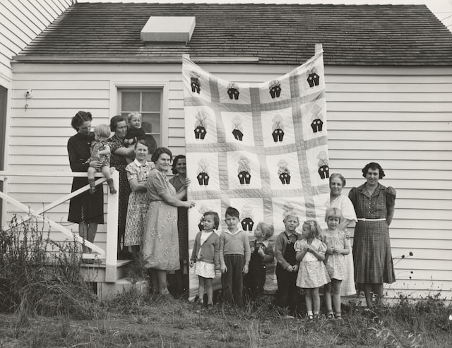 1939 - Farm women of the "Helping Hand" club display a pieced quilt which they are making for the benefit of one of their numbers. Near West Carlton, Yamhill County, Oregon. Photographer - Dorothea Lange