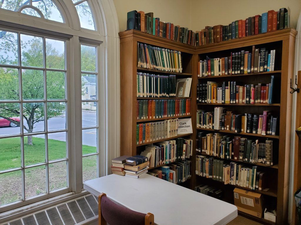 Photograph of corner bookshelves with local interest resources and study table