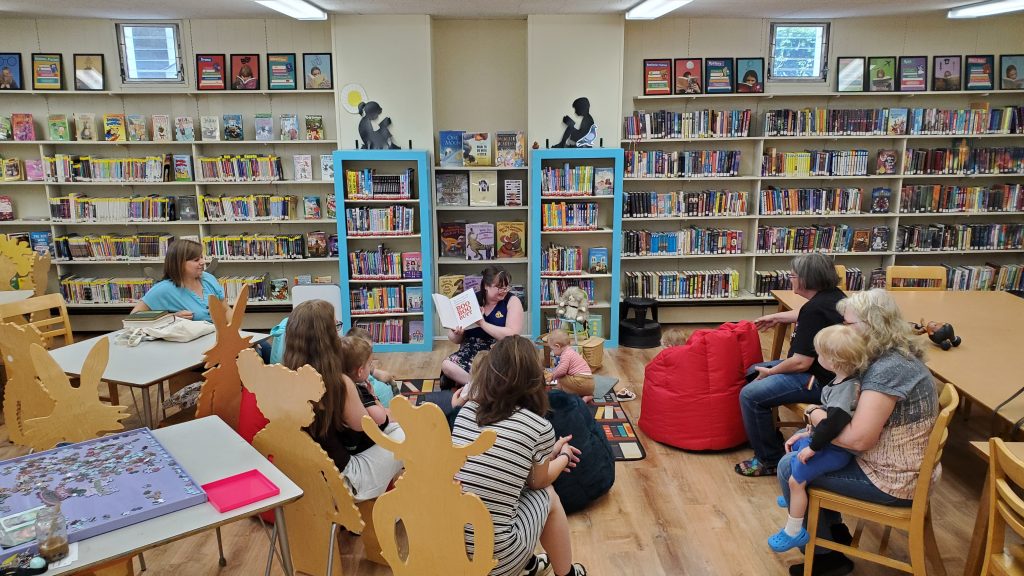 Photo of librarian reading to families